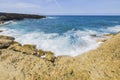 Beautiful view of big waves of Caribbean sea breaking on rocky coast of coast of island of Aruba.