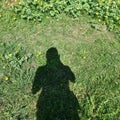 Beautiful view of black shadow of person on green grass field background