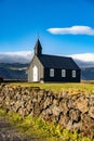 Beautiful view of a black wooden church in Budir, Iceland, vertical shot