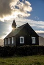 Beautiful view of a black wooden church in Budir, Iceland, vertical shot