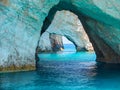 Beautiful view on Blue Caves rock arches from sightseeing boat with tourists in blue water of Ionian Sea inside Blue cave. Island Royalty Free Stock Photo