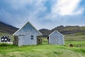 Beautiful view of blue faded wooden barn with green grass of she