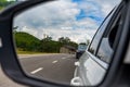 Beautiful view of blue sky and white clouds from car rearview mirror Royalty Free Stock Photo