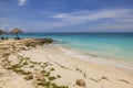 Beautiful view of blue waters of Caribbean Sea on island of Aruba, with sandy beach equipped with sun umbrellas Royalty Free Stock Photo