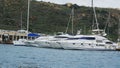 Beautiful view of boats moored at a harbor against green hills Royalty Free Stock Photo