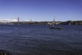 Beautiful view of the Bridge 25th of April over the river Tagus in the heart of Lisbon in Portugal. Small sailing boat and fishing Royalty Free Stock Photo