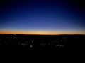 Beautiful view of the bright skyline over the dark cityscape at night