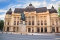 Beautiful view of the building of the Central University Library with equestrian monument to King Karol I in Bucharest, Romania Royalty Free Stock Photo