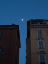 Beautiful view of buildings in a blue sky background with full moon Royalty Free Stock Photo