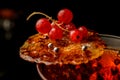 beautiful view of burnt caramel crust with red currant on glass of drink Royalty Free Stock Photo