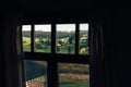 Beautiful view from cabin window on green mountain hills with forest and wooden houses in sunny day. Trees and woods in Carpathian Royalty Free Stock Photo