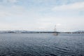 Beautiful view of calm sea, fjord and sailing boat, ship on cold winter day in Oslo Royalty Free Stock Photo