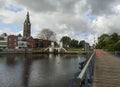 Beautiful view of the canal, bridge, church and houses in the Dutch city of Vlaardingen on a cloudy day