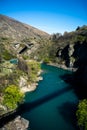 Beautiful view of a canyon with the bridge in the background taken on a sunny spring day in Kawarau Bridge, New Zealand