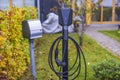 Beautiful view of charging station for electric car in front yard of townhouse. Royalty Free Stock Photo