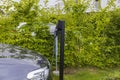 Beautiful view of charging station for electric car in front yard of townhouse. Royalty Free Stock Photo