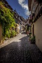 Beautiful view of charming street scene with colorful houses in the historic town of Eguisheim on an idyllic sunny day with blue Royalty Free Stock Photo