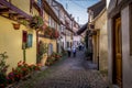 Beautiful view of charming street scene with colorful houses in the historic town of Eguisheim on an idyllic sunny day with blue Royalty Free Stock Photo