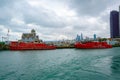 Beautiful view of Chicago city skyline fire rescue boats coast under gray cloudy sky Royalty Free Stock Photo