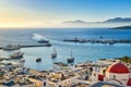 Beautiful view of Chora, Mykonos, Greece at sunset. Port, bay, boats, yachts moored by jetty. Famous whitewashed houses Royalty Free Stock Photo