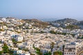 Beautiful view of Chora town of Mykonos at sunset, Greece. Whitewashed houses, hills, greenery, seafront, famous