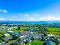 Beautiful view of Gisborne in New Zealand with buildings on the green field under the clear blue sky
