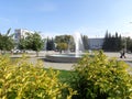 Beautiful view of the city Park with a fountain in the green ornamental shrubs in the summer of the city of Berdsk