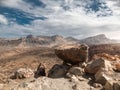 Beautiful view from the cliff edge on big stones, high mountains and dry volcanic desert Royalty Free Stock Photo