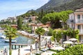 Beautiful view of the coast of Lake Garda with vacationing people in the hot summer day.