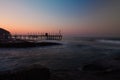 Beautiful view on coast pier on rocky beach. Royalty Free Stock Photo