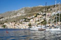 View of the Colorful Neo-Classical Houses, and Sailboats in the Harbor of Symi, Greece Royalty Free Stock Photo