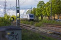 Beautiful view of coming speed electric train passing crossroad in town.