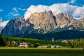Beautiful view of Cortina d`Ampezzo town with alpine green landscape and massive Dolomites Alps in the background. Province of Royalty Free Stock Photo