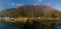 Beautiful view of creek with reflections blue sky, light clouds, fog, mountains and trees on water Royalty Free Stock Photo