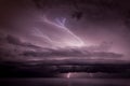 Beautiful view of dark cloudy sky with lightening over the sea at night