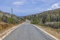 Beautiful view of desert of natural park Arikok on island of Aruba with asphalt road for vehicles. Royalty Free Stock Photo