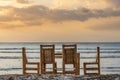 Beautiful view of a dining table on the beach with a scenery of sunset Royalty Free Stock Photo