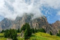 Beautiful view of the Dolomites Alps in the fog after summer rain near town Colfosco Calfosch Italian Dolomites Royalty Free Stock Photo