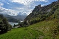 A beautiful view down a hillside, looking across a lake with mountains and old buildings from the old Italian town, Castel di Tora Royalty Free Stock Photo