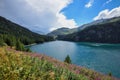 Beautiful view of the emerald alpine lake. Dramatic and picturesque scene. Mountain lake in the background of mountains and sky Royalty Free Stock Photo