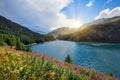 Beautiful view of the emerald alpine lake. Dramatic and picturesque scene. Mountain lake in the background of mountains and sky Royalty Free Stock Photo