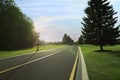 Beautiful view of empty asphalt road and green trees on sunny day Royalty Free Stock Photo