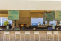 Beautiful view of empty outdoor bar with open fire stove. Turquoise water surface and blue sky on background.