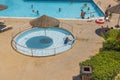 Beautiful view of empty outdoor pool with sun umbrella in middle for babies. Greece.