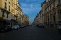 Beautiful view of an Empty Paris street with parked cars and old residential buildings, France