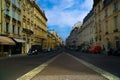 Beautiful view of an Empty Paris street with parked cars and old residential buildings, France