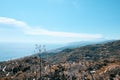 Beautiful view of the erupting Etna mountain with smoke rising and expanding on the sky above the Ionian Sea Royalty Free Stock Photo