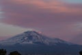 A beautiful view of the eruption of volcano Etna with smoke and snow is in the photo in winter in Sicily Royalty Free Stock Photo