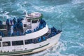 Beautiful view of excursion boat full with tourists in blue clothes. Tourist concept. Transportation concept.Niagara falls.