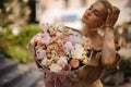 beautiful view of expensive floral bouquet of different flowers in the hands of woman